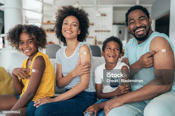 Portrait Of A Vaccinated Family Stock Photo - Download Image Now - Vaccination, Family, Adhesive Bandage