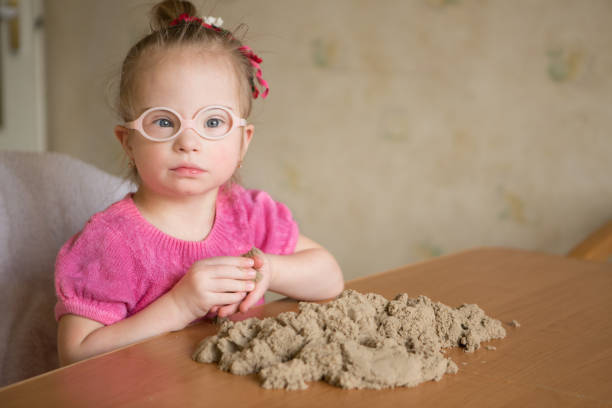 Twin girls with playing in sandbox.