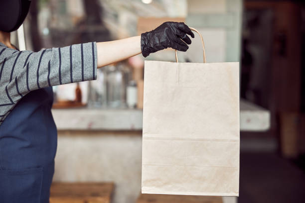 istock Woman cafe worker serving unrecognizable customer outdoors 1350102637