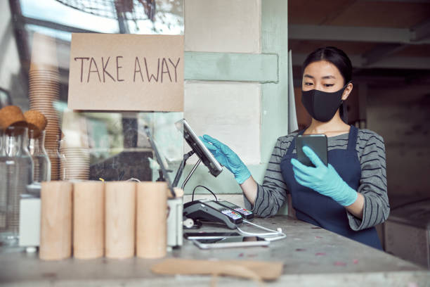 istock Female cafe worker taking online orders indoors 1350102642