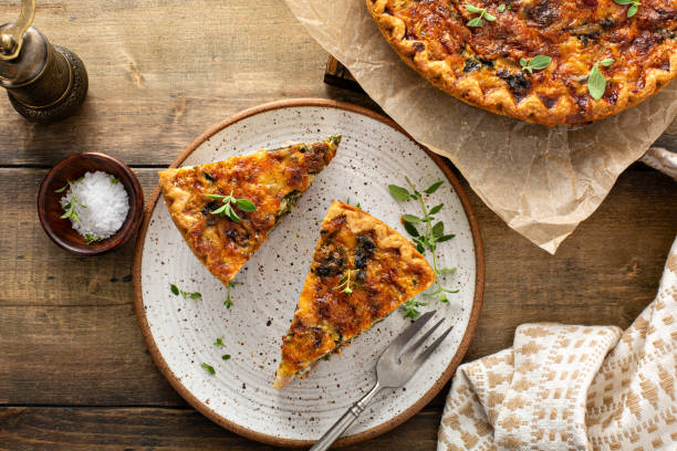 Bacon, mushroom and spinach quiche with cheese and herbs