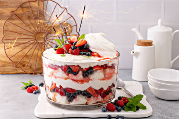 Summer berry trifle with angel food cake in a large bowl Summer berry red, white and blue trifle with angel food cake in a large bowl. Dessert for 4th of July, Independence day sweet treat with sparklers trifle stock pictures, royalty-free photos & images