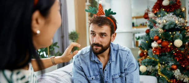 istock a cheerful young couple having fun during the Christmas holidays 1350105225