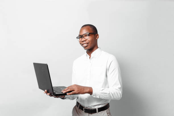 istock Professional confident black african man hold a laptop business technology concept. 1350109056