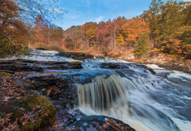 Shohola Falls in the Pennsylvania Poconos on a beautiful fall morning surrounded by peak fall foliage stock photo
