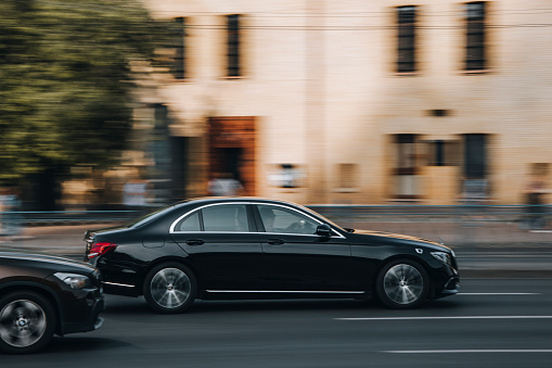 Ukraine, Kyiv - 16 July 2021: Black Mercedes-Benz E-Class AMG car moving on the street. Editorial