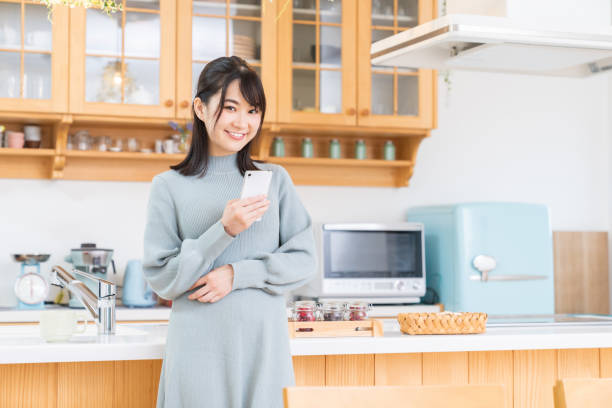 istock attractive Asian woman using a smart phone 1350118113