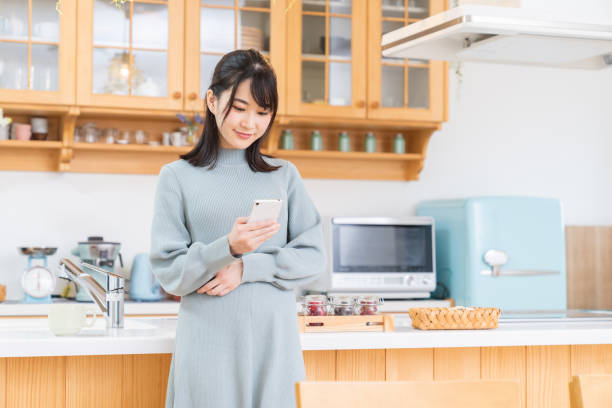 istock attractive Asian woman using a smart phone 1350118752