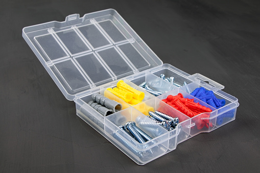 Set of colorful dowel, screw, fastener. A box with dowel, bolt and screw. Set of building tools
