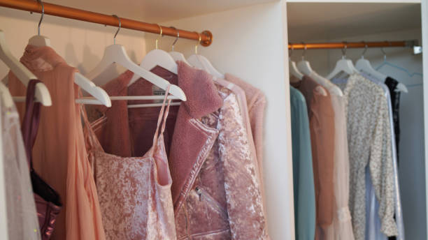 istock Close up of hangers with different clothes in wardrobe 1350118938