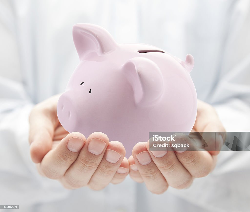 Man holding pink piggy bank Adult Stock Photo