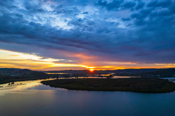 istock Sunrise waterscape with colourful cloud covered sky 1350124511