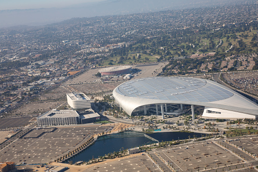 Los Angeles, California USA, September 2021- Aerial view of the So-Fi stadium in Los Angeles, And behind it, a view of the Forum.  The SoFi is an entertainment complex located in Inglewood, Los Angeles. Airplane window viewpoint.