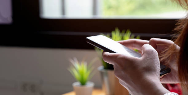 istock Close up hand of woman using smartphone, texting text message, hipster touch screen on smartphone light bokeh, girls using in hands cellphone close up, online internet 1350129900