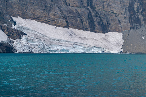Glacier on the shoreline of Iceberg Lake in Glacier National Park
