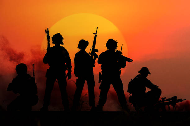 The silhouette of a military soldier with the sun as a Marine Corps for military operations stock photo