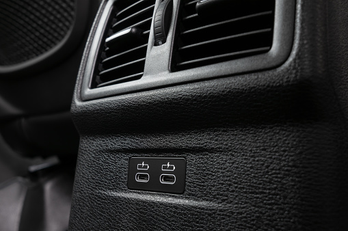 Rear vents and USB Type-C ports inside a modern vehicle.