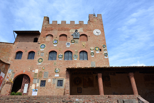 The Palazzo Pretorio, the residence of the Florentine governors, adorned with ceramic coats of arms, the landmark of Certaldo, a town and comune of Tuscany, Italy, in the Metropolitan City of Florence, in the middle of Valdelsa.