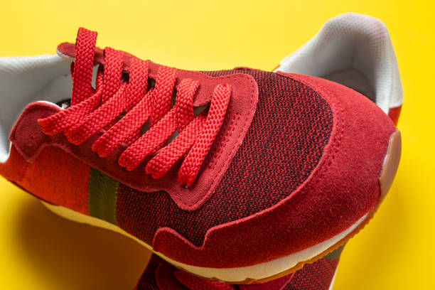 istock New red sneakers on a yellow background. space for text. 1350158300