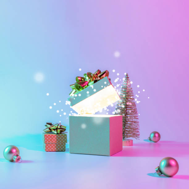 istock Neon xmas winter background. Open Christmas gift box with shine lights, minimal tree. Holiday decoration bauble ball on neon abstract gradient backdrop. Happy new year copy space. 1350159881