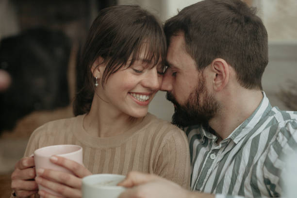 istock Couple drinking coffee by the window 1350160066