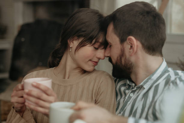 istock Couple drinking coffee by the window 1350160067