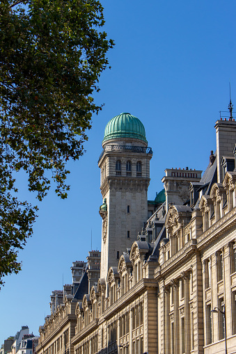 This image shows a cityscape view of the exterior stone architecture of the Sorbonne University in Paris, a public research university established in 2018, with the merger of Paris-Sorbonne University and  Pierre et Marie Curie University.