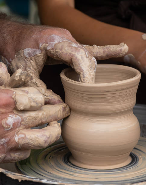 istock Master class on modeling of clay on a potter's wheel In the pottery workshop 1350167602