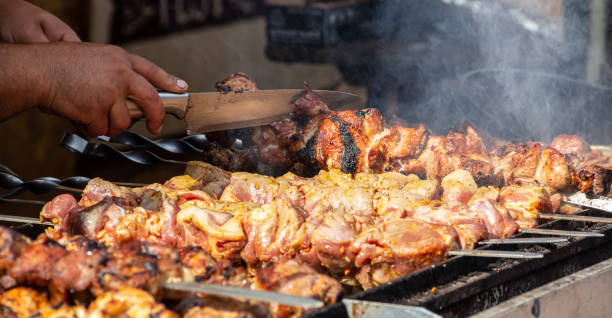 istock Marinated shashlik preparing on a barbecue grill over charcoal. Shashlik or Shish kebab popular in Eastern Europe. Shashlyk, skewered meat, was originally made of lamb. Roast Beef Kebabs On BBQ Grill 1350167656