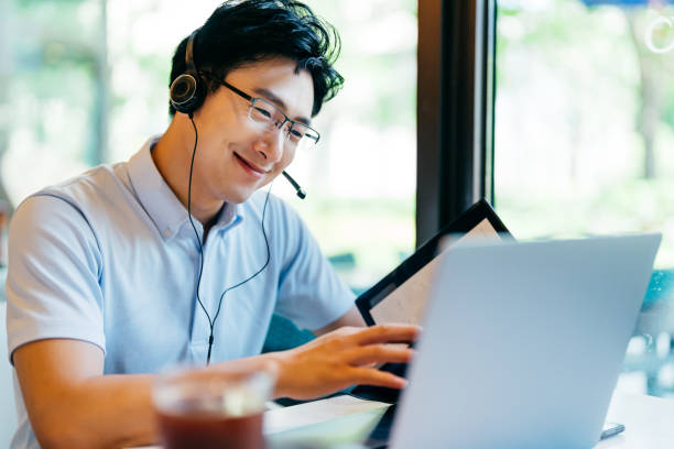 istock Asian  young man having video call on laptop. 1350171286