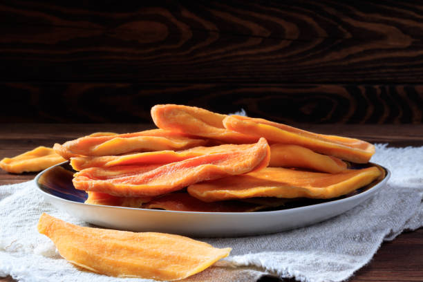 istock Close-up view of dried mango slices on a plate. Selective focus. 1350178315