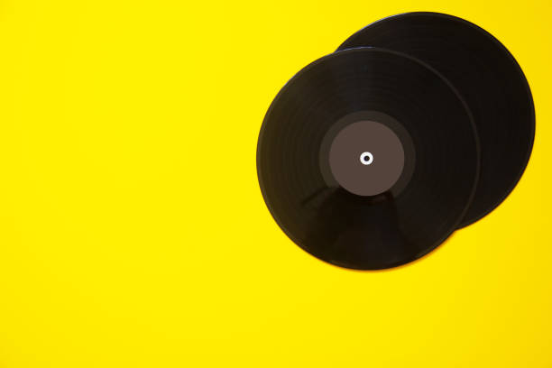 istock Two vinyl retro disc records on a yellow background 1350179846