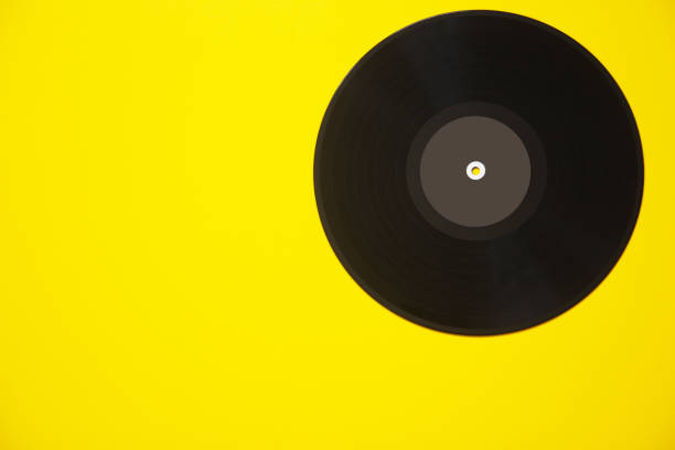istock Vinyl retro disc record on yellow background 1350179850