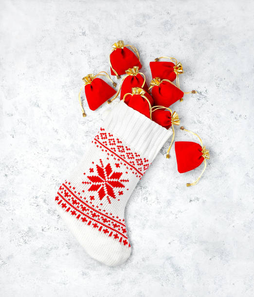 istock Christmas stocking with gifts on a light background. View from above. 1350180701