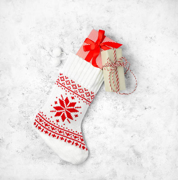 istock Christmas stocking white with boxes of gifts on a light background. 1350183519