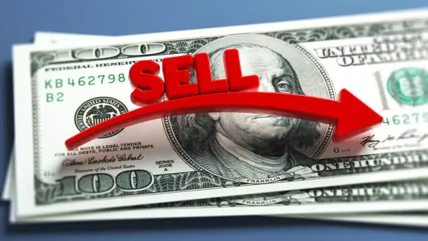 Red-colored arrow, sell text, and American hundred dollar bill. On grayish blue-colored background. Horizontal composition with copy space. Focused image.