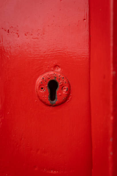 istock Red old lock key hole in wooden door painted bright 1350196084