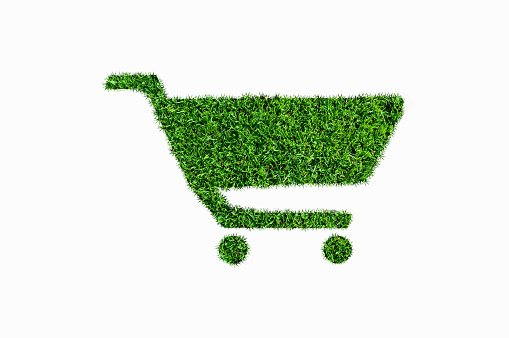 Shopping cart or trolley filled with grass, Sale, discount, ecology concept. Sustainable lifestyle, conscious consumption. eco-shop, organic food. vegetarian, vegan, local products, sustainability.