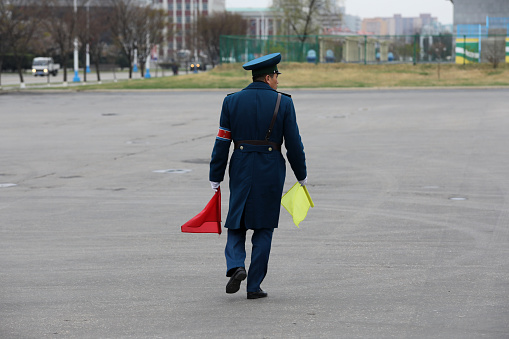 April 14, 2018. Pyongyang, North Korea. \nThere are a lot of streets in North Korea, and there are lots of traffic police on these streets. Although there are ample avenues, there are very few cars. Traffic cops often control cyclists and pedestrians.