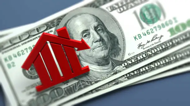 Red-colored house icon and American hundred dollar bill. On grayish blue-colored background. Horizontal composition with copy space. Focused image.