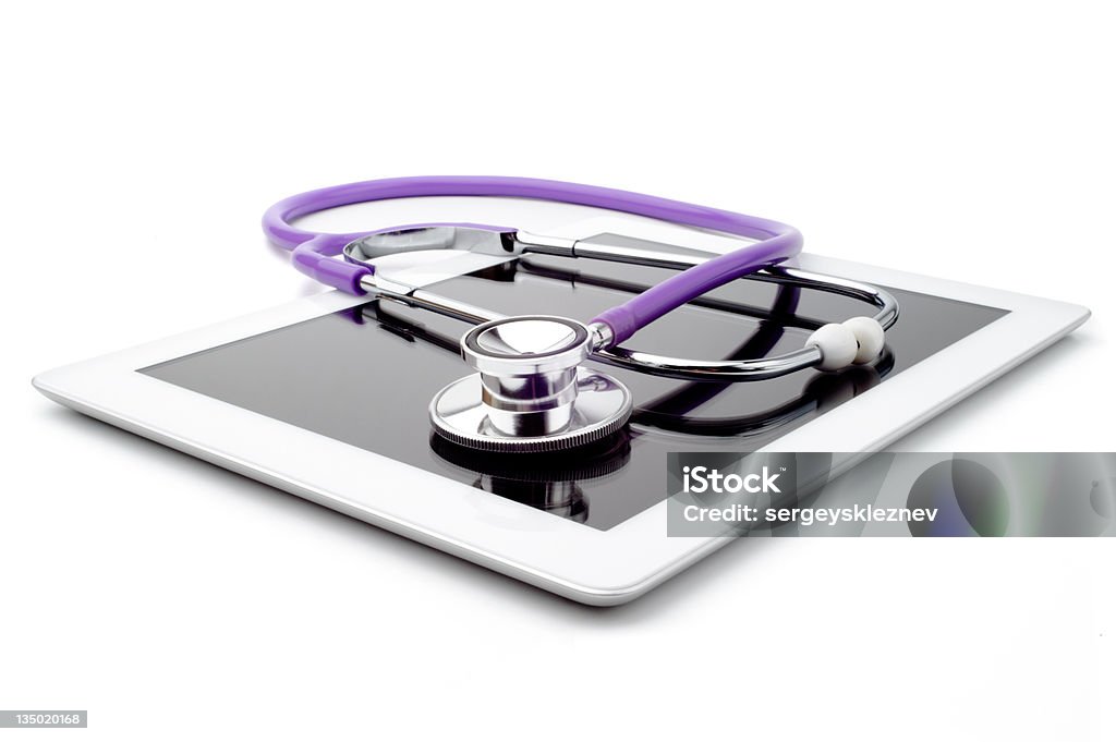 Purple stethoscope on top of white digital tablet Stethoscope and tablet, isolated on a white background Stethoscope Stock Photo