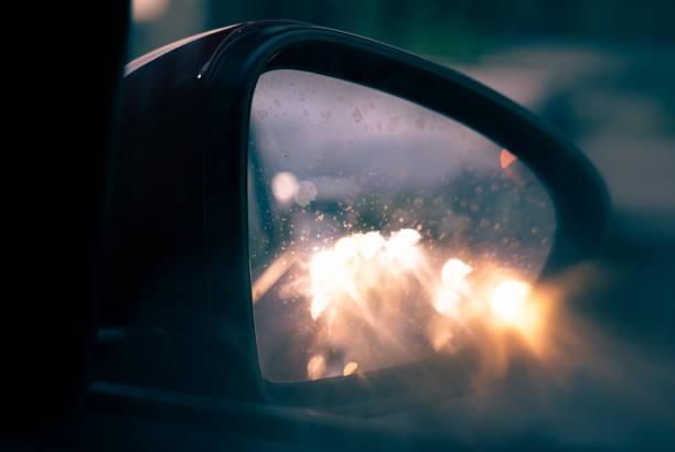 istock Car lights reflected in the rear view mirror 1350203400