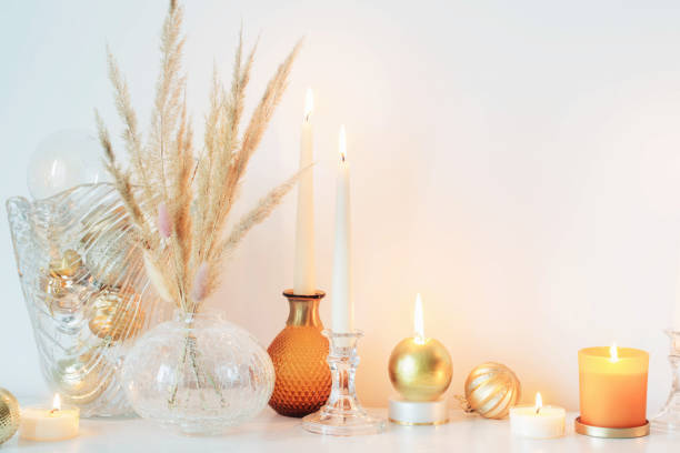istock christmas decorations with burning candles in white room 1350203783