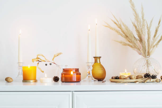 istock autumn home decorations with burning candles 1350203785