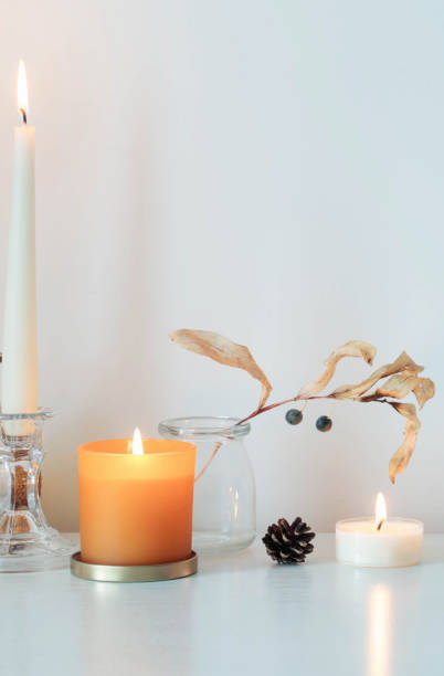 istock autumn home decorations with burning candles 1350203791
