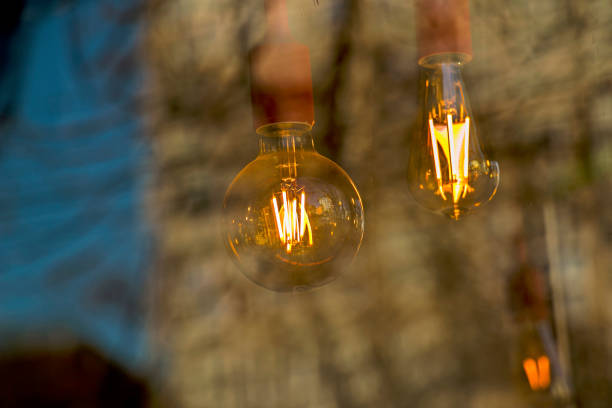 Background image of outdoor lighting garlands , focus on classic light bulb with wiring. Background image of outdoor lighting garlands , focus on classic light bulb with wiring. Copy space. n11 stock pictures, royalty-free photos & images