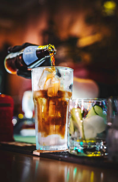 hands of a bartender with black gloves making cocktail on a bar counter. hands of a bartender with black gloves making cocktail on a bar counter. club soda stock pictures, royalty-free photos & images