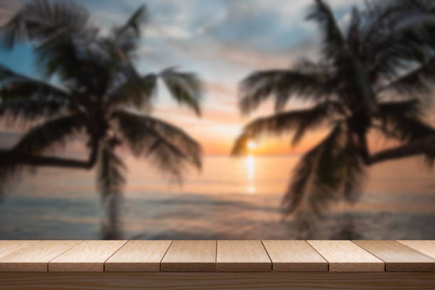 istock Empty brown wooden table on sunset on the beach blurred background. For display your product. 3D illustration rendering. 1350207009