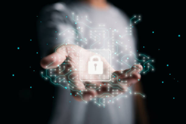 istock Businessman uses a digital security hologram to protect his data. 1350208546