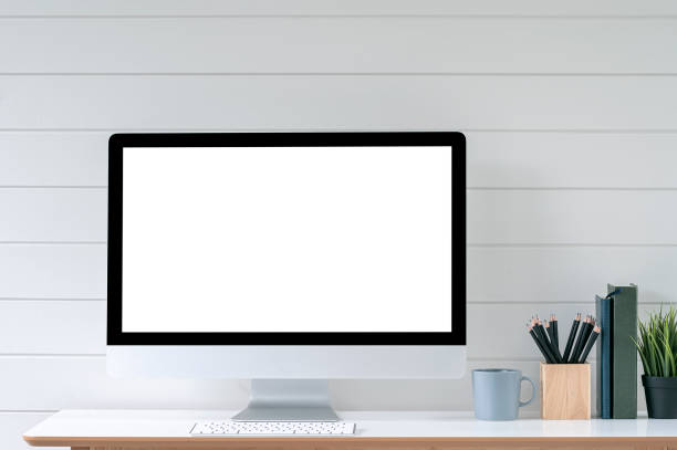 istock Blank screen desktop computer in minimal office room with decorations and copy space. 1350213961